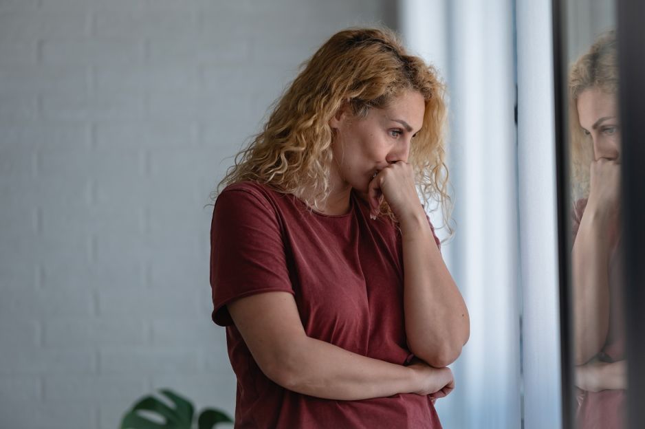 smutna kobieta w oknie